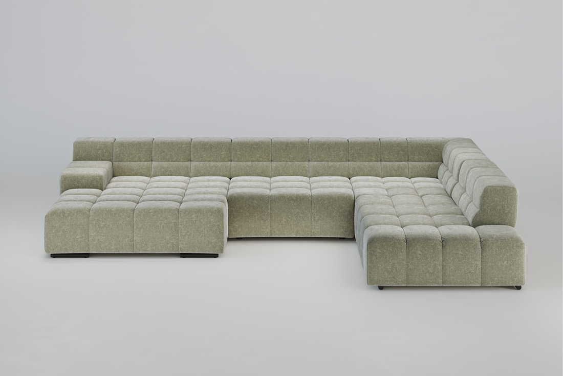Großes, hellgrünes, getuftetes L-förmiges Sektionssofa auf einem schlichten, hellen Hintergrund.